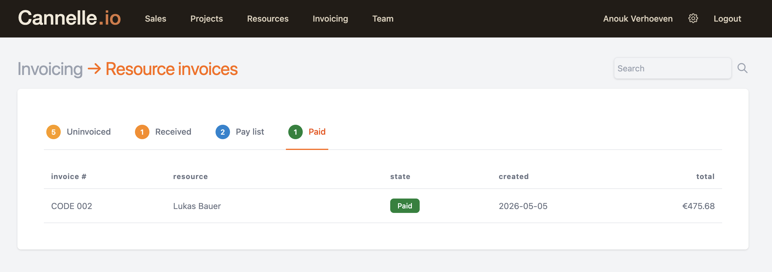 The Paid tab showing a paid invoice with a green Paid badge